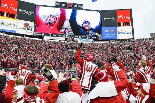 Fans and the UW Marching Band jumping
