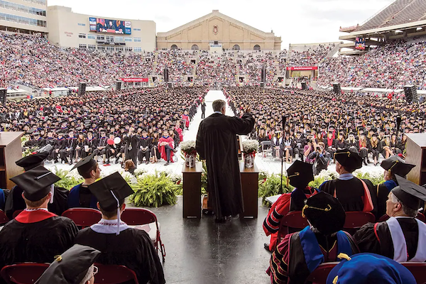 A speaker on the podium in front of UW-Madison graduates