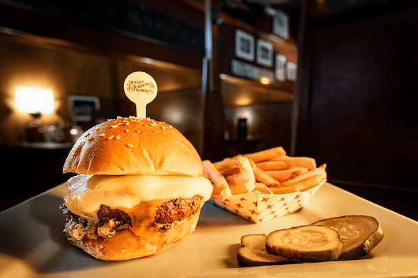A burger and fries on a plate.